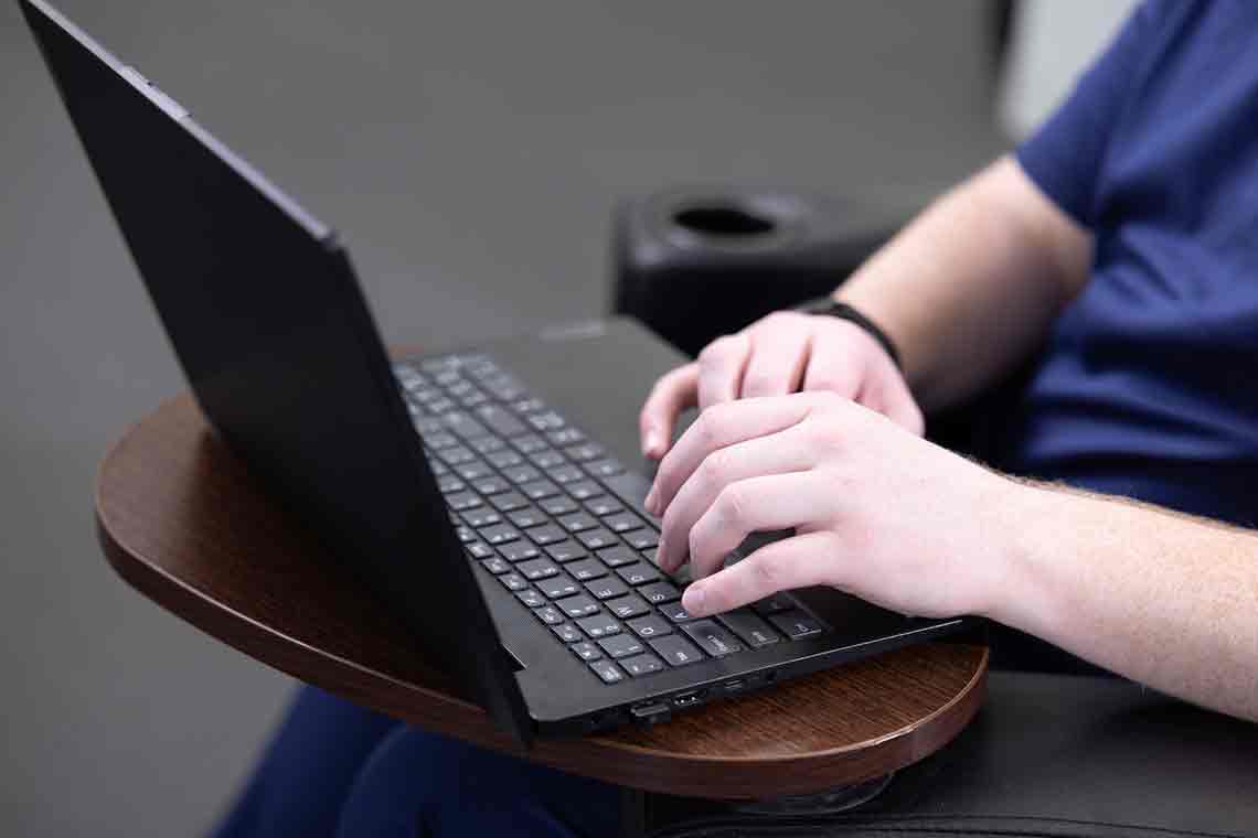 Nursing student typing on laptop