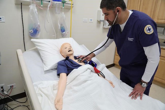 Ruben, a Marquette nursing student, participating in a simulation lab